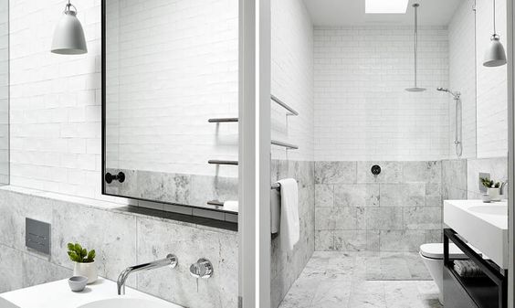 Mismatched tiles and minimal fixtures in this open shower give it a traditional sense among the modernity.