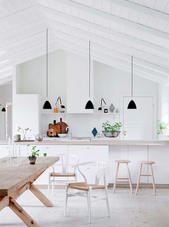 The lightness of this white kitchen goes from floor to painted ceiling.