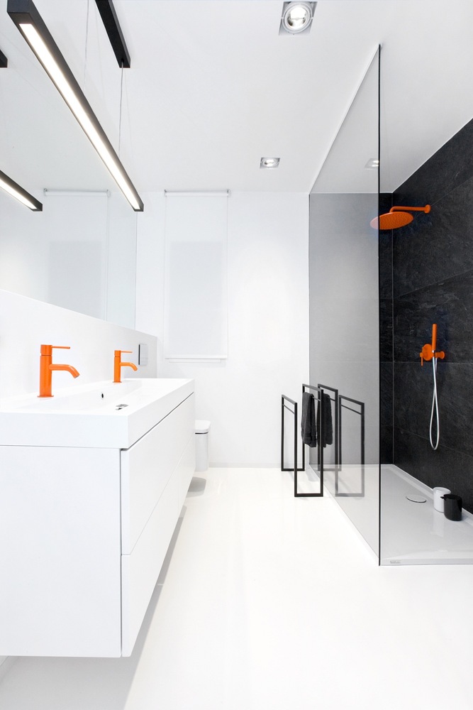 While not quite a linear bathroom layout, the glass divider allows this funky, modern space to feel open and clean. I love the pop of color, but can imagine I would be tired of it quickly.