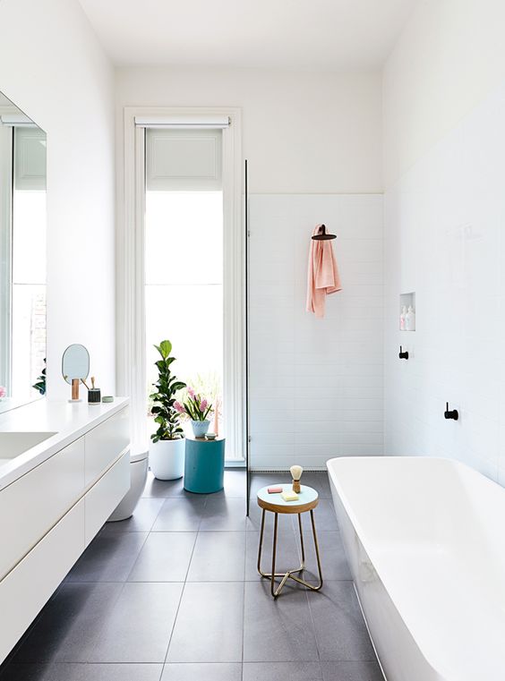 This grouped bathroom layout makes use of its relatively small rectangle for all necessary functions while also remaining a semblance of privacy for certain needs and openness in general. The whites and minimal fixtures are very calming.