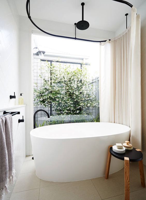 This giant soaking tub in Port Melbourne by Bloom Interior Design looks big enough to be a small sailboat. Fed either from a floor fixture or rainfall head from above, this looks like heaven. The garden right outside the window is just icing on the cake. #ThisOldHouse inspiration via www.L-2-Design.com