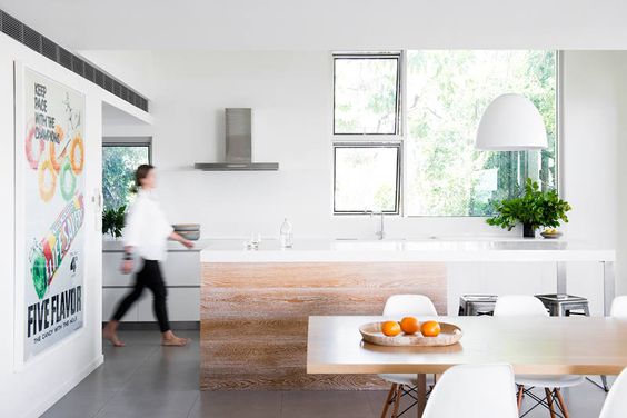 Zooming out to a partial view of a minimal kitchen with lots of windows and no wall shelves. The boxed openings and simple lines help create a clean, calm feel. While this is in a penthouse in Australia, it would be easy to picture this in northern Spain...or most anywhere. #ThisOldHouse kitchen inspiration via www.L-2-Design.com