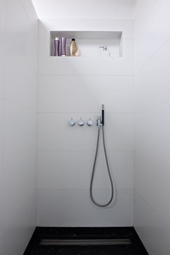 Large-format, horizontal tile. Simple hardware. Linear trough drain. The shower details in this bathroom would definitely make me excited about waking up in the morning. #ThisOldHouse shower inspiration via www.L-2-Design.com