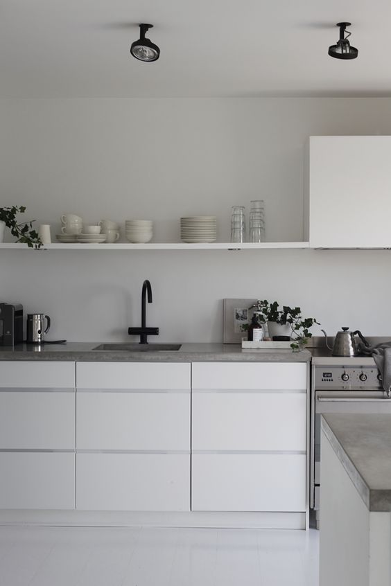 The simple lines of the concrete countertop in the image below are mirrored in the single open shelf in line with the range above. The grey of the counter grounds and separates the white shelves below and above. So simple and clean it makes my heart happy. #ThisOldHouse inspiration via www.L-2-Design.com