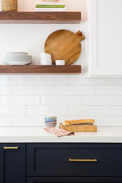 A beautiful set of dark cabinets topped off with warm wood open shelves and bright what subway tile? What more could a girl want? Wine. A girl wants wine - in this kitchen, of course. #ThisOldHouse kitchen inspiration via www.L-2-Design.com