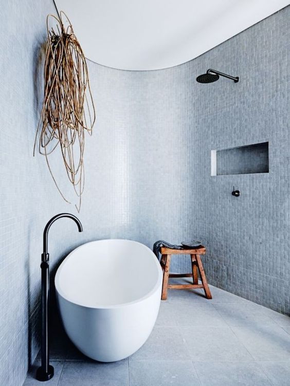 There's something so serene about this open tub shower layout. Every piece of the design is so minimal that it lets the details sing. The curve bounces light around in the space and the light blue-grey tile makes it seem like you might be swimming in an ocean while you shower. #ThisOldHouse inspiration via www.L-2-Design.com